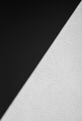 Black Shadows and Bright Sunlight on a Stucco Wall in Monochrome.