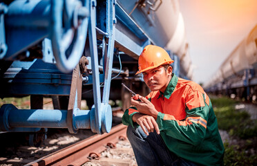 Engineer under inspection and checking construction process railway oil train and checking work on...