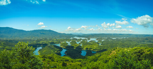 Morning at the Ta Dung lake or Dong Nai 3 lake with green hills and mountains. Travel and landscape concept. Travel concept.