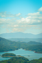 Fototapeta premium Morning at the Ta Dung lake or Dong Nai 3 lake with green hills and mountains. Travel and landscape concept. Travel concept.
