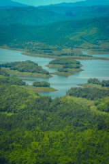 Fototapeta na wymiar Morning at the Ta Dung lake or Dong Nai 3 lake with green hills and mountains. Travel and landscape concept. Travel concept.