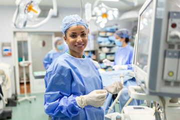 Anesthesiologist checking monitors while sedating patient before surgical procedure in hospital...