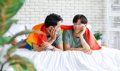 Portrait shot two Asian young lovely pride male gay men lover couple partner smiling laying down...