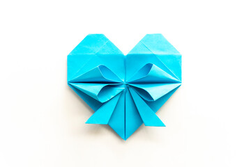 blue heart made of origami paper on a white background. love concept