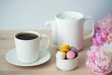 Tea time. Cup of tea with a teapot and macaroon.