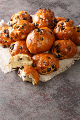 Krentenbollen Dutch Fresh baked Currant Rolls closeup on a table. Vertical