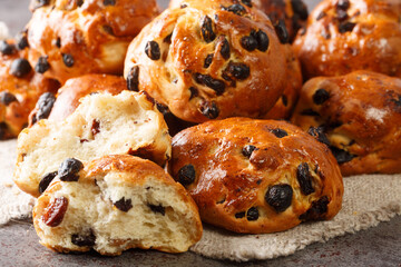 Freshly baked buns with raisins traditional european pastry close-up on the table. horizontal