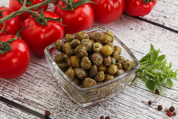 Marinated green capers in the bowl