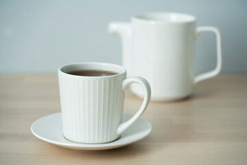 Tea time. Cup of tea with a teapot.