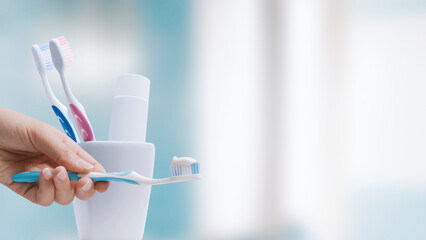 Woman holding a toothbrush with toothpaste