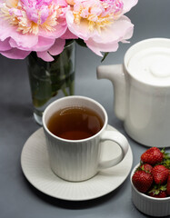 Сup of tea, peony and berries.