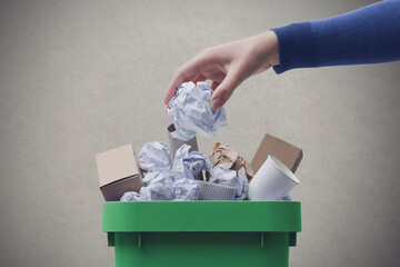 Woman putting paper in the waste bin