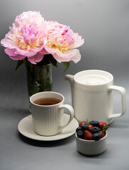 Сup of tea, peony and berries.