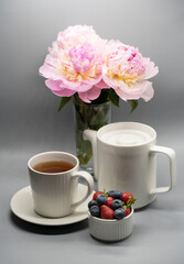 Fototapeta na wymiar Сup of tea, peony and berries.