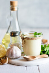 Aioli sauce on a on white wooden background, selective focus