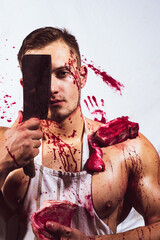 Brutal butcher. Shirtless butcher with wearing bloody apron posing with fresh raw meat. © Volodymyr