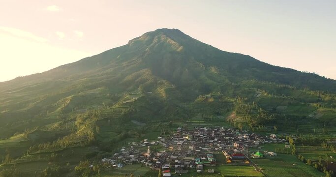 birds eye view over a village on the Dieng plateau with mount Sindoro in the wonosobo region in central java indonesia