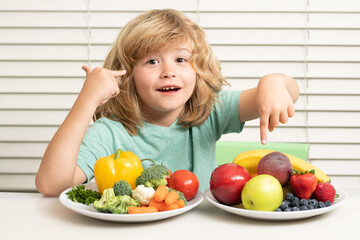 Fruits and vegetables. Child eats organic food. Healthy vegetables with vitamins. Proper kids...