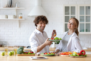 Young beautiful healthy couple preparing a vegetarian breakfast. Spending time together at home, healthy food.