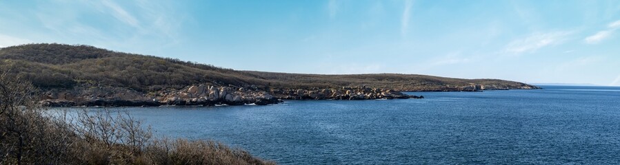 Panorama of a beach with sand and stones near the Black Sea under sunset light in Bulgaria