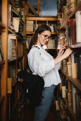Portrait of a student girl studying at library
