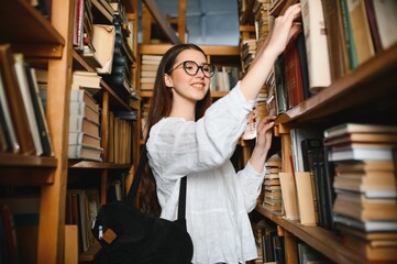 Portrait of a student girl studying at library