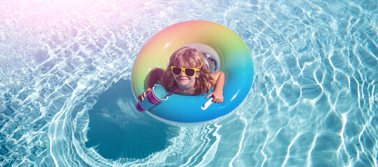 Playful summer kid at beach with rubber circle. Summertime activities or adventure at aquapark. Child weekend or vacation. Banner for design header, copy space.
