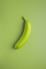 Unripe green banana on green table. © Jiri Hera