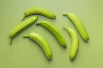 Unripe green bananas on green table. © Jiri Hera