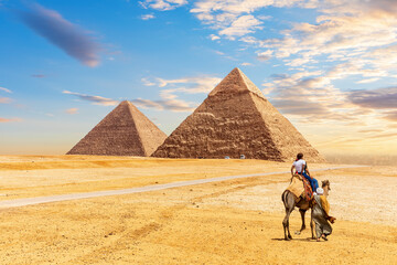 The Egypt Pyramids Khafre and Cheops and bedouin with tourists in the Giza desert