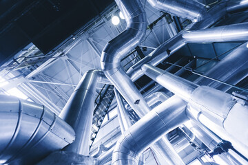 Industrial concept background blue toning. Steel pipelines, valves gas and oil refinery plant...