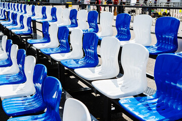 Blue and white plastic seats in a sports stadium. selective focus