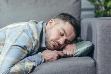 Close up photo of man sleeping on sofa at home