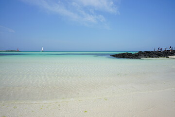 shoaling beach and people and boat