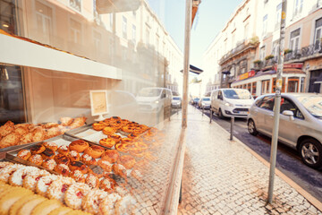 Delicious desserts and sweets in the showcase window of pastry shop on the Lisbon street.