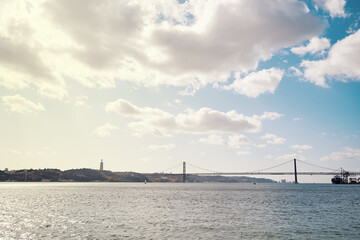 Fototapeta premium Beautiful landscape with suspension 25 April bridge bridge over the Tagus river in Lisbon, Portugal.