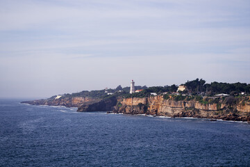 Fototapeta na wymiar Guia Lighthouse. Cascais rock coast of Atlantic Ocean, Portugal.
