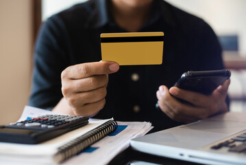 Closeup Men Holding Hand Credit Card.Businessman Use Smartphone Online Payments Shopping.Guy Touching Screen Mobile Phone Name Numbers.