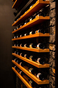 Wine bottles displayed on wood shelving