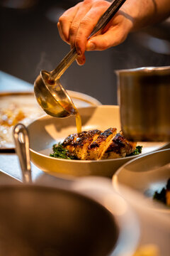 Pouring Sauce Over Food From Ladle