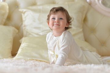 Beautiful little girl on the bed