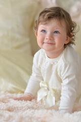 Beautiful little girl on the bed