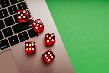 Red dice on a keyboard. Top view. Online gambling and casino concept