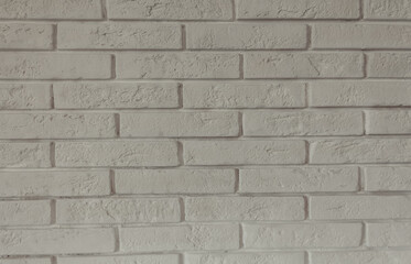 White decorative brick wall close up. Horizontal brick tile texture background. Scandinavian interior.