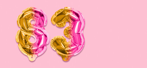 Rainbow foil balloon number, digit eighty three on a pink background. Birthday greeting card with inscription 83. Top view. Numerical digit. Celebration event, template. Banner