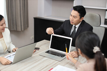 Collaborative process of professional businesspeople going over on new project together, using computer presentation and brainstorming ideas, coworker and working together at office meeting concept