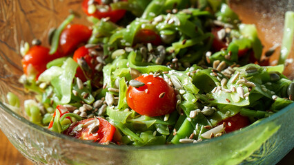 Green beans salad with sunflower seeds, tomatoes, flax seeds, and sesames. 