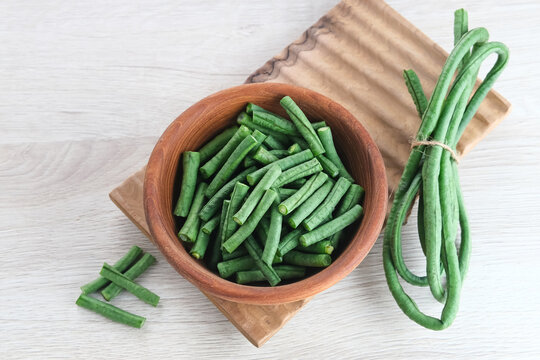 Yard long bean or Kacang Panjang served in wooden bowl, food preparation.

