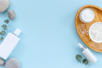 White cosmetic products with bottle and tube, top view