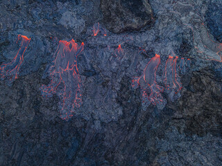 View of an active lava flow from above. red hot magma flows from a volcano on the Reykjanes...
